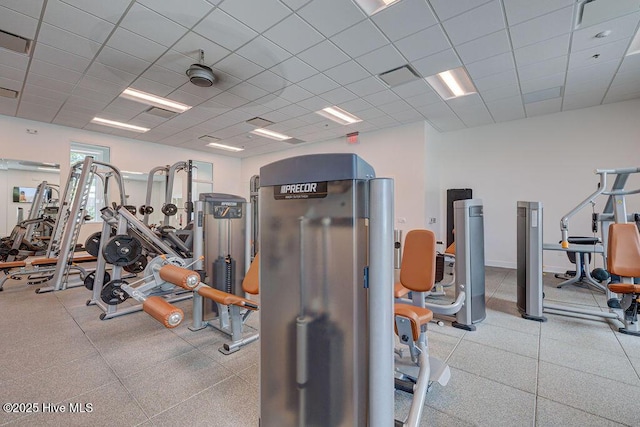 exercise room with a paneled ceiling