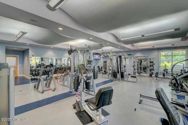 exercise room with recessed lighting and baseboards