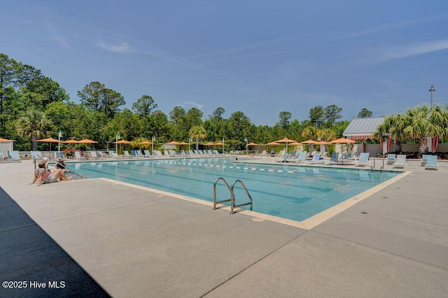 community pool featuring fence and a patio