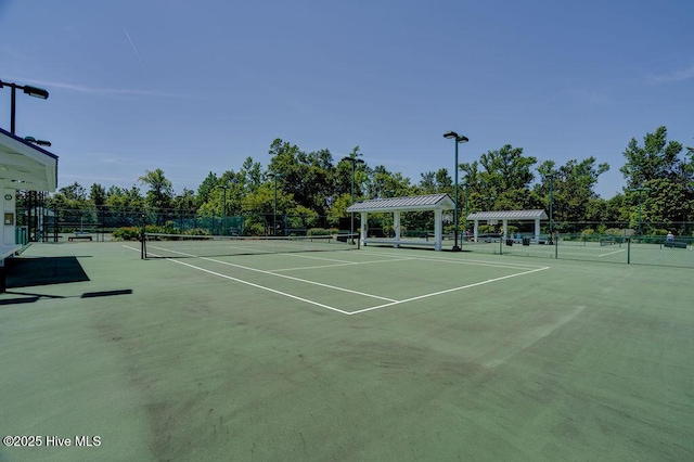 view of tennis court with fence