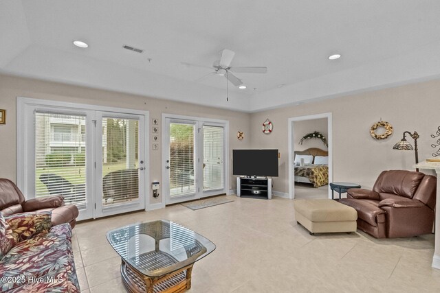 908 Resort Cir Unit 701, Sunset Beach, NC 28468 - living area featuring a tray ceiling, light tile patterned flooring, visible vents, and ceiling fan