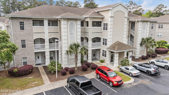 908 Resort Cir Unit 701, Sunset Beach, NC 28468 - view of building exterior with uncovered parking