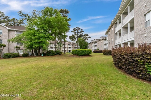 908 Resort Cir Unit 701, Sunset Beach, NC 28468 - view of property's community with a yard and a residential view
