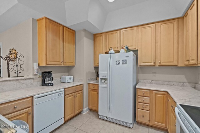 908 Resort Cir Unit 701, Sunset Beach, NC 28468 - kitchen featuring light tile patterned flooring, light stone counters, and white appliances