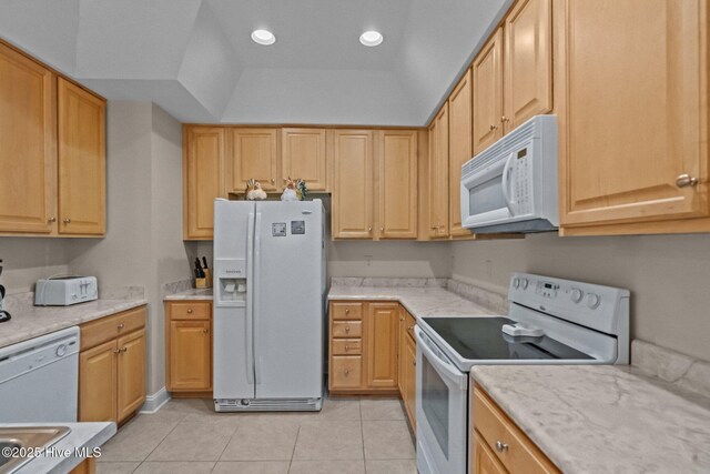 908 Resort Cir Unit 701, Sunset Beach, NC 28468 - kitchen with recessed lighting, light countertops, a tray ceiling, white appliances, and light tile patterned flooring