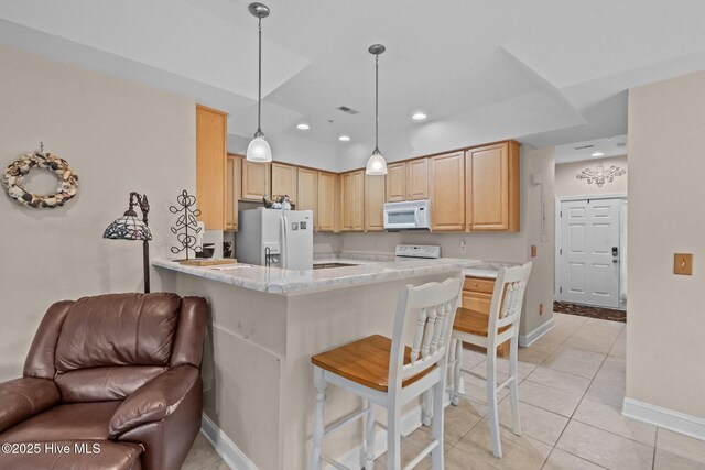 908 Resort Cir Unit 701, Sunset Beach, NC 28468 - kitchen featuring open floor plan, light brown cabinetry, baseboards, and white appliances