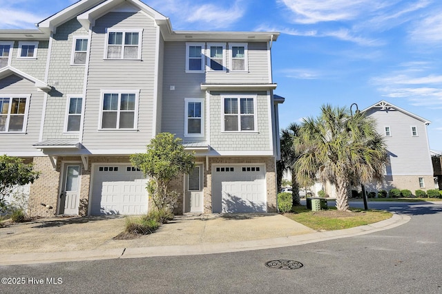 multi unit property featuring an attached garage and driveway