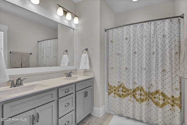 bathroom featuring a sink, baseboards, a shower with curtain, and double vanity