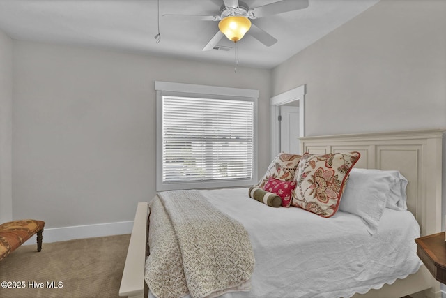carpeted bedroom with baseboards, a ceiling fan, and visible vents