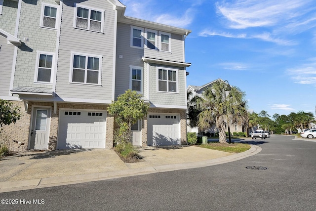 townhome / multi-family property with a garage, concrete driveway, and stone siding