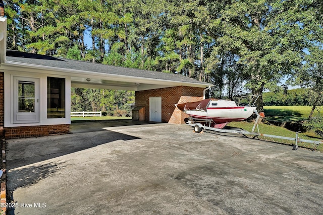 view of vehicle parking featuring driveway and an attached carport