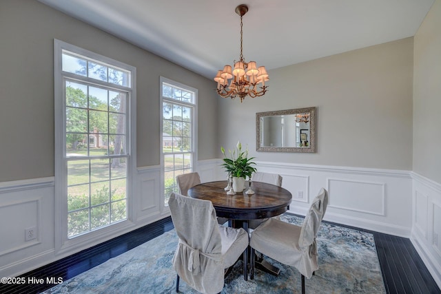7240 Orchard Trce, Wilmington, NC 28409 - dining area featuring dark wood-type flooring, a notable chandelier, and wainscoting