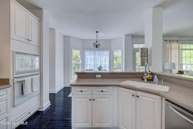 7240 Orchard Trce, Wilmington, NC 28409 - kitchen featuring an inviting chandelier, a sink, white appliances, white cabinetry, and baseboards