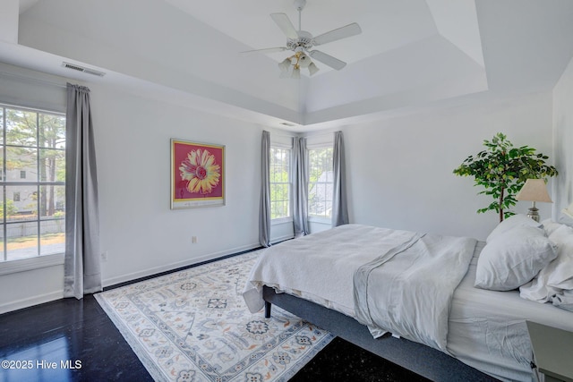 7240 Orchard Trce, Wilmington, NC 28409 - bedroom with a raised ceiling, dark wood-type flooring, a ceiling fan, visible vents, and baseboards