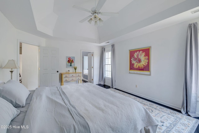 7240 Orchard Trce, Wilmington, NC 28409 - bedroom with baseboards, a ceiling fan, and a tray ceiling