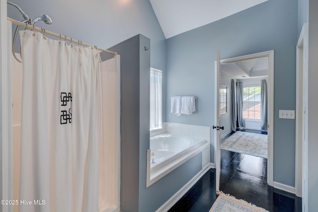 7240 Orchard Trce, Wilmington, NC 28409 - full bath featuring curtained shower, a garden tub, vaulted ceiling, and baseboards
