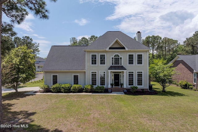 7240 Orchard Trce, Wilmington, NC 28409 - colonial-style house featuring a chimney, a shingled roof, and a front yard