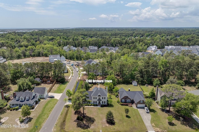 7240 Orchard Trce, Wilmington, NC 28409 - drone / aerial view featuring a wooded view and a residential view