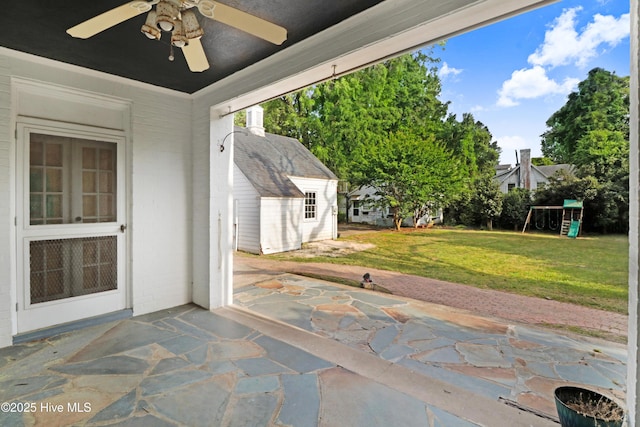 view of patio with a playground and a ceiling fan