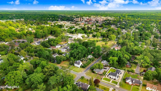 birds eye view of property featuring a wooded view and a residential view