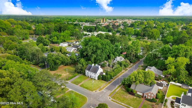 aerial view featuring a wooded view and a residential view