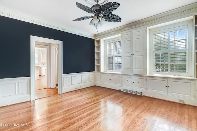 interior space with a wealth of natural light, a ceiling fan, visible vents, and light wood-style floors