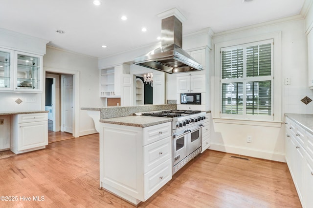 kitchen featuring range with two ovens, baseboards, island exhaust hood, open shelves, and white cabinets