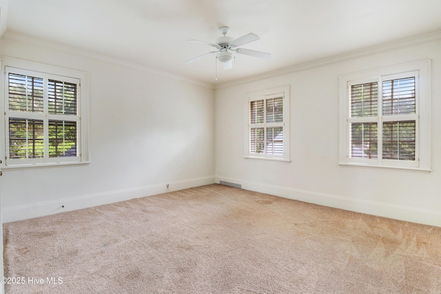 spare room featuring ceiling fan, ornamental molding, carpet, and baseboards
