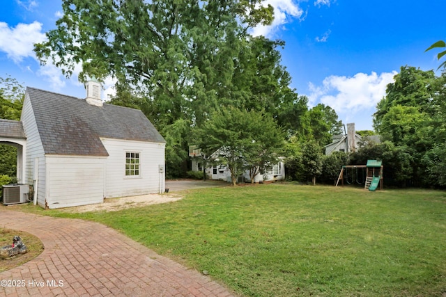 view of yard featuring cooling unit and a playground