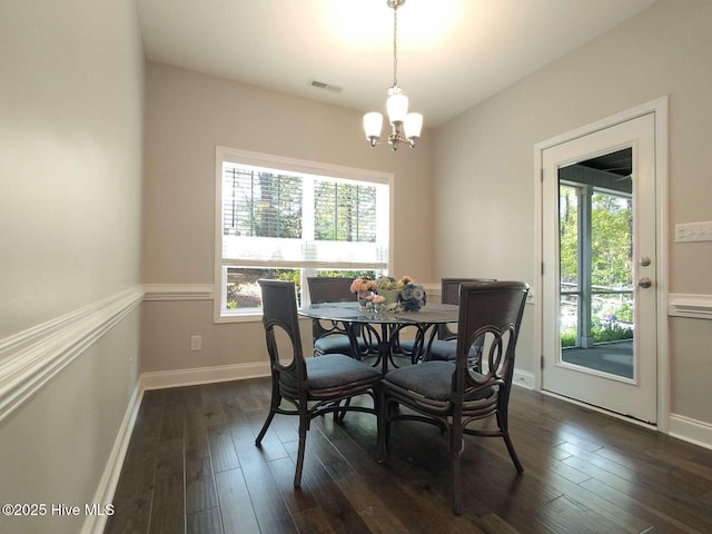 112 Schever Rd, West End, NC 27376 - dining room with a chandelier, dark wood finished floors, and baseboards