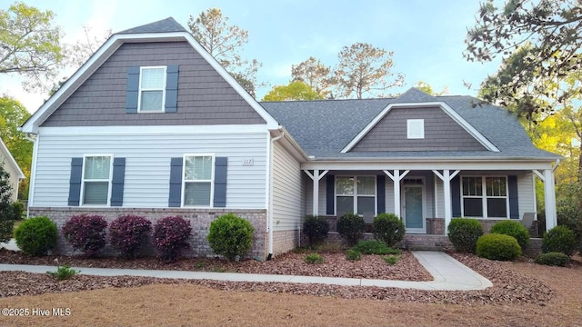 112 Schever Rd, West End, NC 27376 - craftsman-style house featuring covered porch and brick siding