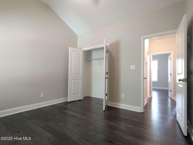 112 Schever Rd, West End, NC 27376 - unfurnished bedroom featuring lofted ceiling, dark wood-style flooring, baseboards, and a closet