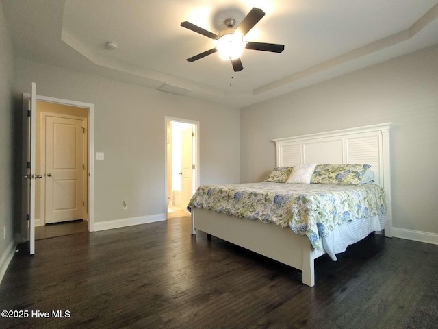 112 Schever Rd, West End, NC 27376 - bedroom featuring a tray ceiling, dark wood-type flooring, baseboards, and ceiling fan