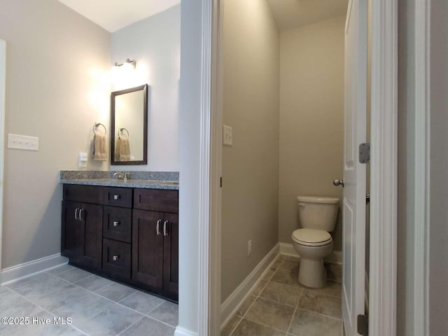 112 Schever Rd, West End, NC 27376 - bathroom featuring vanity, tile patterned flooring, toilet, and baseboards