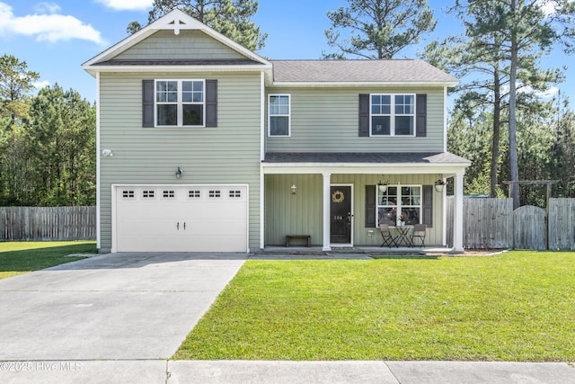 traditional-style house featuring driveway, a porch, a front lawn, and fence