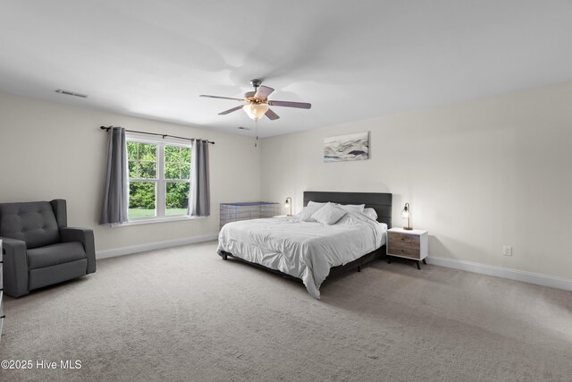 bedroom featuring baseboards, visible vents, carpet floors, and ceiling fan