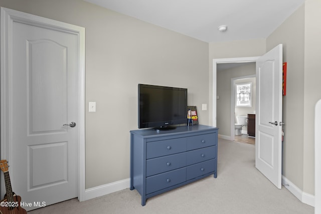 bedroom with light carpet and baseboards