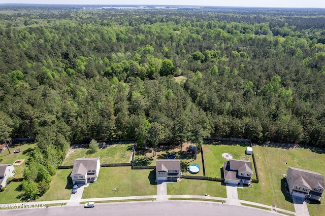birds eye view of property featuring a wooded view