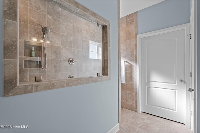 bathroom with walk in shower and tile patterned flooring