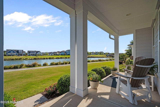 view of patio / terrace with a water view and a residential view