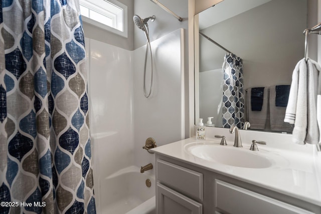 bathroom with shower / bath combo and vanity