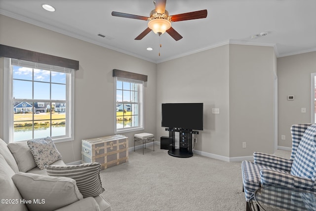 carpeted living area featuring baseboards, ceiling fan, recessed lighting, and crown molding