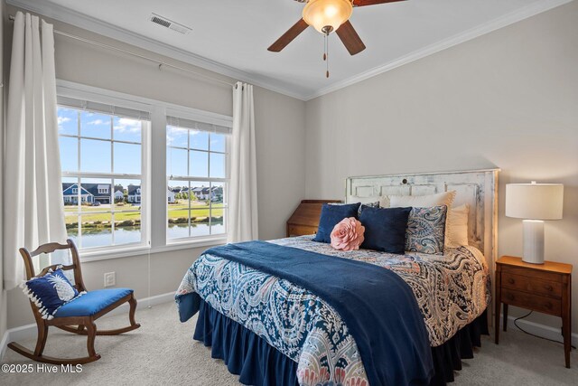 carpeted bedroom featuring ornamental molding, baseboards, ceiling fan, and a water view