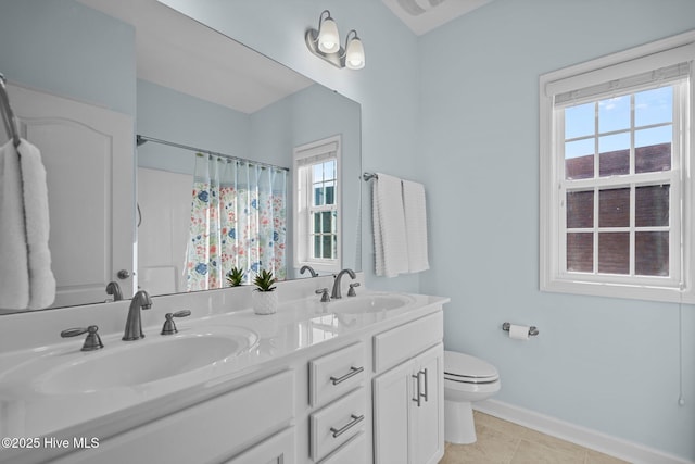 full bathroom with toilet, baseboards, double vanity, a shower with shower curtain, and tile patterned flooring
