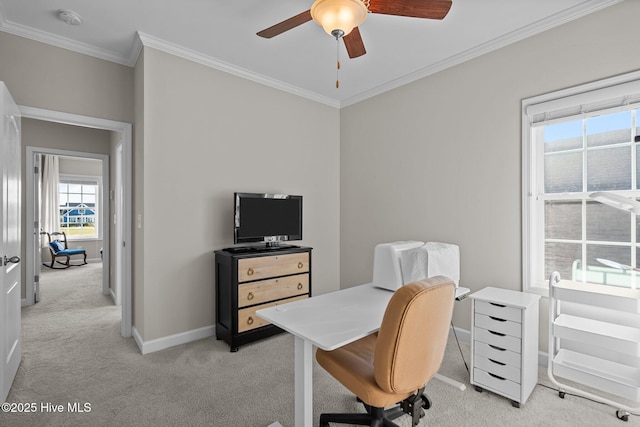 office space with light carpet, a ceiling fan, crown molding, and baseboards
