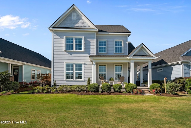 view of front facade featuring covered porch and a front yard