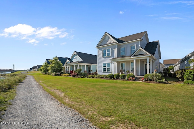 view of front of property featuring covered porch and a front yard