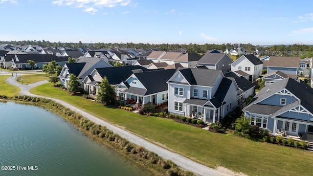 aerial view of residential area featuring a nearby body of water