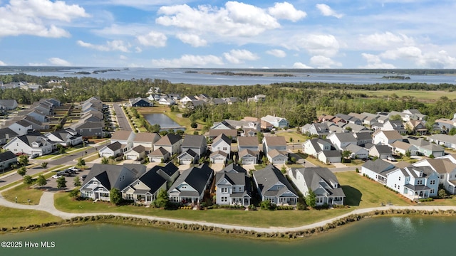 aerial view of residential area featuring a large body of water