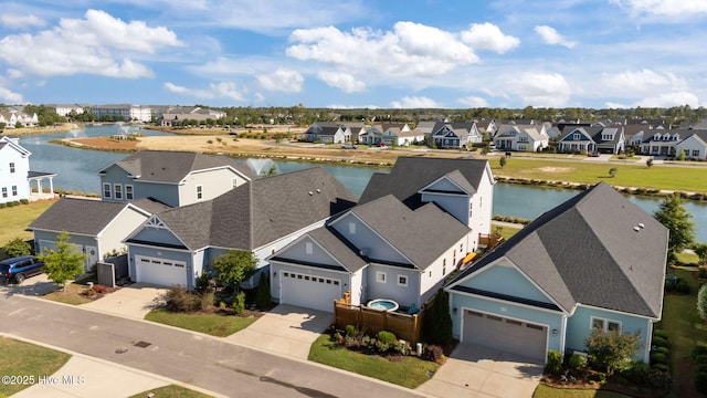 aerial view of residential area featuring a nearby body of water